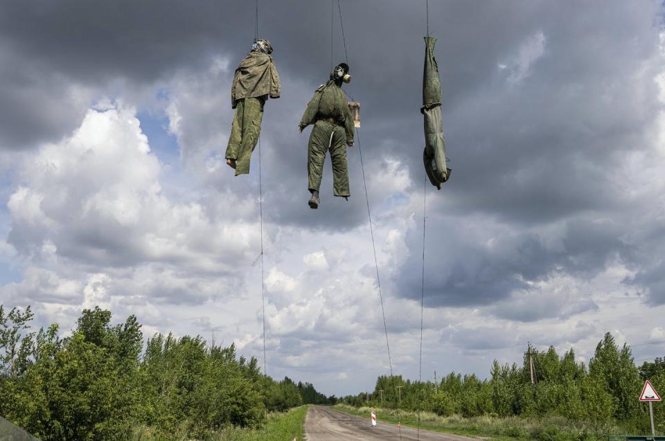 Dummies depicting Russian soldiers are seen hanging near the frontline in the Kharkiv region, Ukraine, on July 23, 2022. (AP Photo/Evgeniy Maloletka)