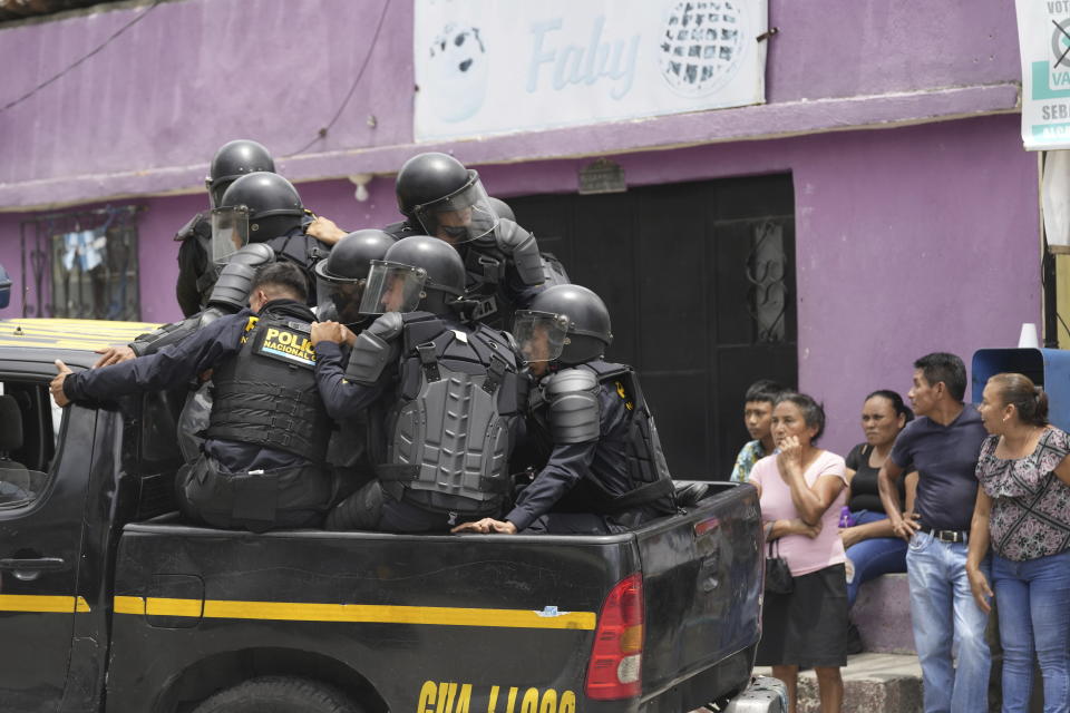 Police arrive to a polling station after clashes erupted when electoral authorities delayed it's opening to voters due to alleged electoral violations during general elections in San Jose El Golfo, outskirts of Guatemala City, Sunday, June 25, 2023. (AP Photo/Moises Castillo)