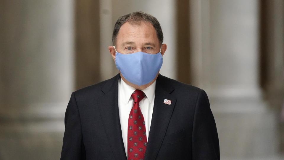 FILE - In this Sept. 22, 2020, file photo, Utah Gov. Gary Herbert walks through the Capitol rotunda to a COVID-19 briefing, in Salt Lake City. Herbert declared a state of emergency, Sunday, Nov. 8, 2020, and ordered a statewide mask mandate in an attempt to stem a surge in coronavirus patient hospitalizations that is testing the state's hospital capacity. (AP Photo/Rick Bowmer, File)