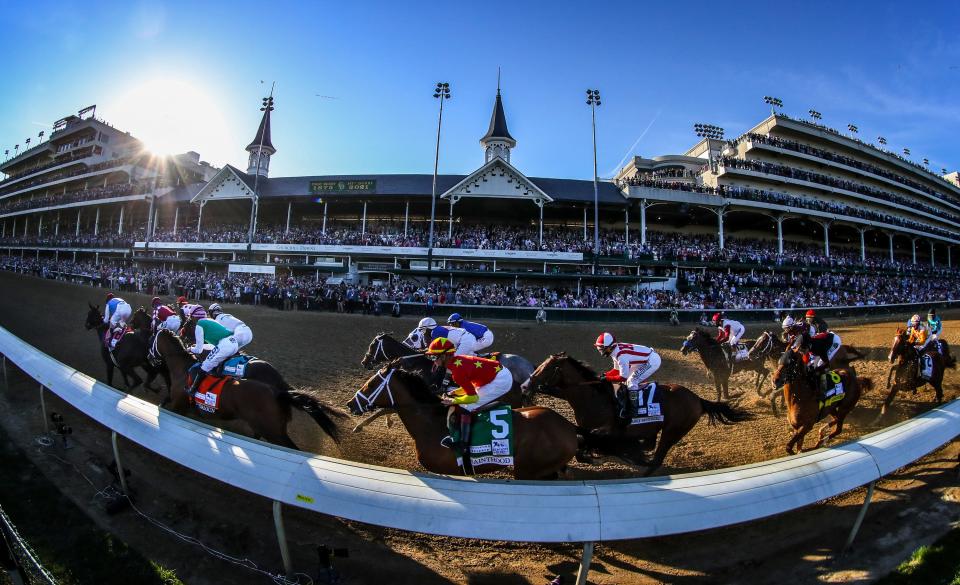 John Velazquez, aboard Medina Spirit, leads the field down the stretch to win the Kentucky Derby.