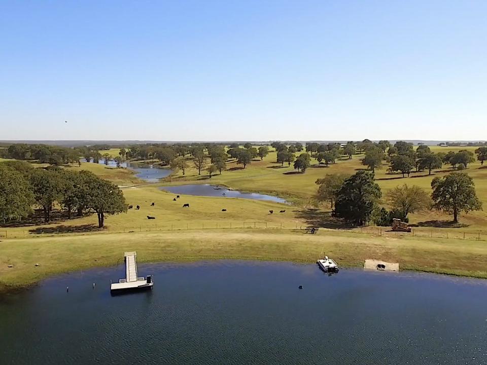 A screenshot shows the aerial view of multiple bodies of water amid rolling fields at Terry Bradshaw's ranch.