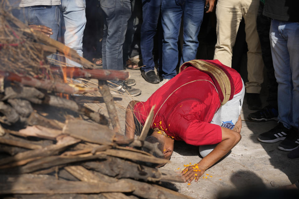 A man performs the final rites of his brother Rahul Bhat, a government employee killed on Thursday, in Jammu, India, Friday, May 13, 2022. Bhat, who was a minority Kashmiri Hindu known as "pandits," was killed by suspected rebels inside his office in Chadoora town in the Indian portion of Kashmir. (AP Photo/Channi Anand)