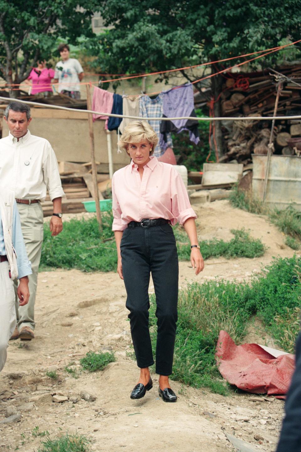 princess diana in a pink shirt and black trousers in bosnia