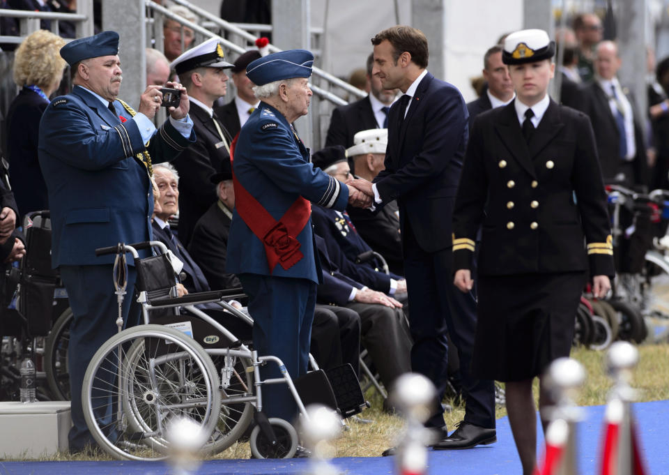 President of France Emmanuel Macron shakes hands with Canadian Lt.-Gen. Richard Rohmer after speaking during the D-Day 75th Anniversary event in Portsmouth, England Wednesday, June 5, 2019. Queen Elizabeth II and world leaders gathered Wednesday on the south coast of England to honor the troops who risked and gave their lives 75 years ago on D-Day, a bloody but ultimately triumphant turning point in World War II. (Sean Kilpatrick/The Canadian Press via AP)