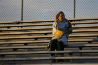 Fifteen year-old Sarah Steenhuysen watches her high school soccer teammates warmup before a game against Bishop Feehan in Attleboro, Massachusetts October 25, 2013. REUTERS/Brian Snyder