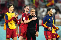 Spain's head coach Luis Enrique, second from right, celebrate with players at the end of the World Cup group E soccer match between Spain and Costa Rica, at the Al Thumama Stadium in Doha, Qatar, Wednesday, Nov. 23, 2022. (AP Photo/Julio Cortez)