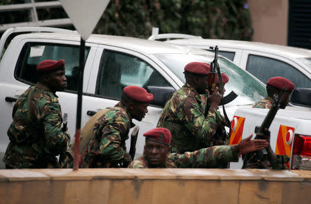 Members of security forces take positions at the scene where explosions and gunshots were heard at the Dusit hotel compound, in Nairobi, Kenya January 15, 2019. REUTERS/Baz Ratner