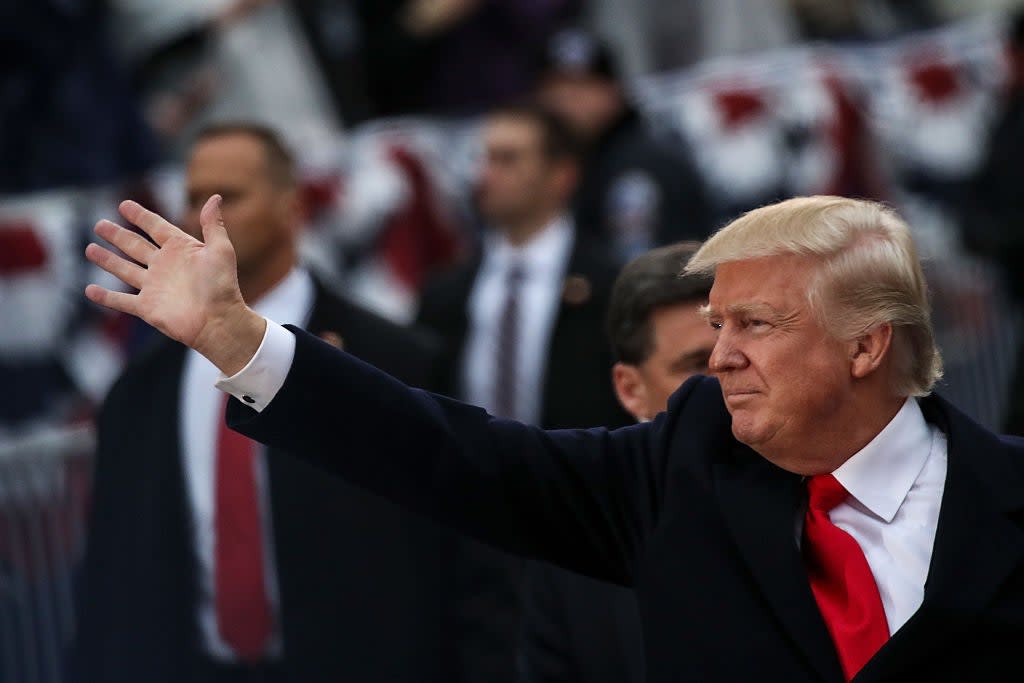 <p>President Donald Trump waves to supporters as he walks the parade route during the Inaugural Parade on 20 January 2017 in Washington, DC</p> (Getty Images)