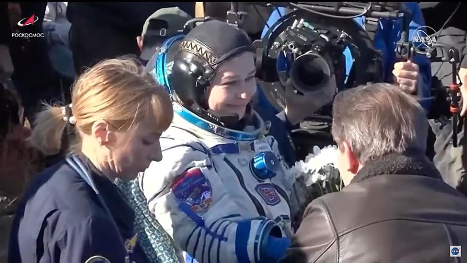 Actress Julia Peresild, playing the role of a surgeon sent to the space station to treat a critically ill cosmonaut, acts out a post-landing welcome home after completing her make-believe mission. / Credit: Roscosmos/NASA