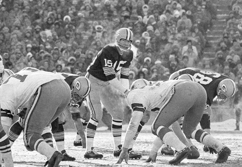 FILE - In this Dec. 31, 1967, file photo, Green Bay Packers quarterback Bart Starr calls signals in bitter cold as he led the Packers to a win over the Dallas Cowboys in Green Bay, Wisc. Fifty years later, players from the Packers and Cowboys still shiver from memories of the bitter cold of a game that would become known as the Ice Bowl. (AP Photo/File)