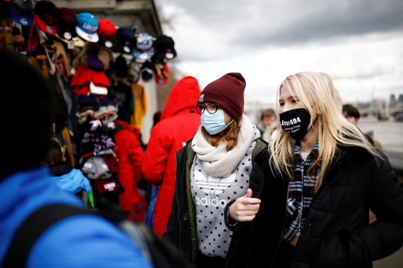 People are pictured wearing protective face masks in London