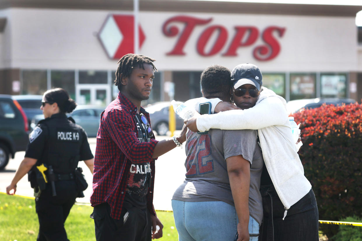 People console each other outside of Tops Friendly Market  (Scott Olson / Getty Images file)