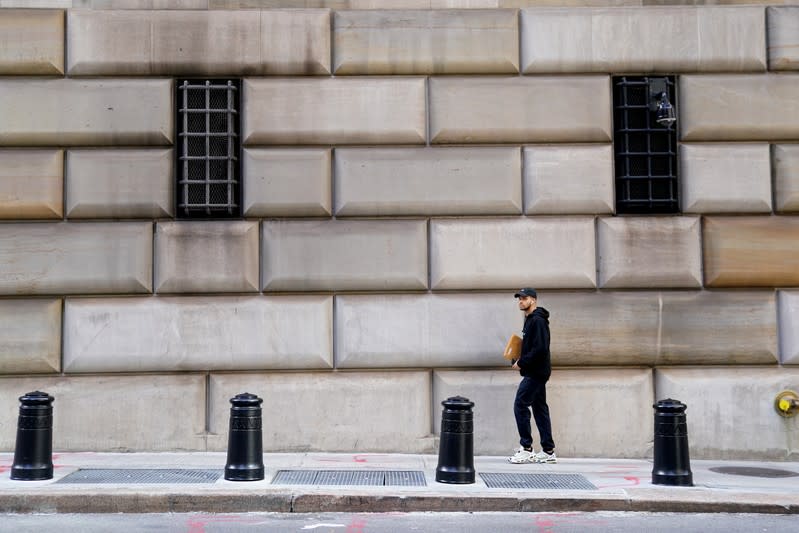 A man walks past the barred windows of the Federal Reserve Bank of New York in the Manhattan borough of New York City