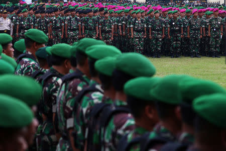 Indonesian military and police personnel attend a security briefing ahead of Jakarta's gubernatorial election in Jakarta, Indonesia April 18, 2017 in this photo taken by Antara Foto. Antara Foto/Rivan Awal Lingga/via REUTERS