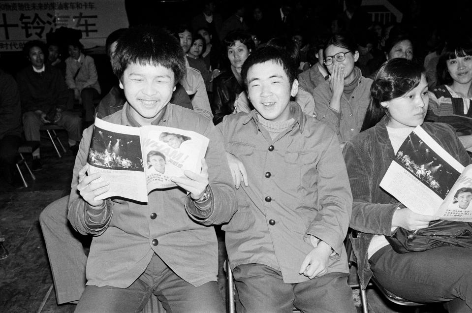 Fans, holding their programs, enjoy the performance of Wham! in China, 1985. (Kent Gavin/Daily Mirror/Mirrorpix/Getty Images)