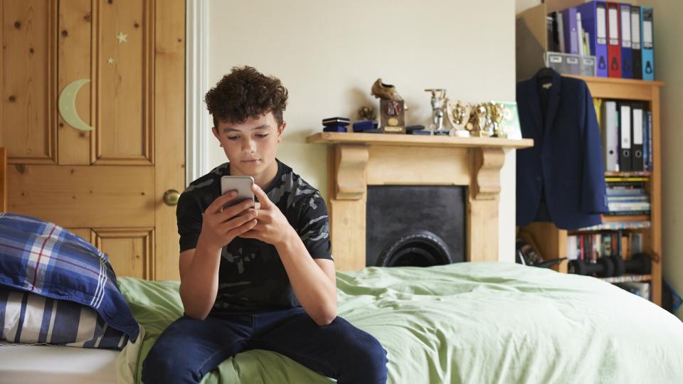 Teen boy looking at smartphon