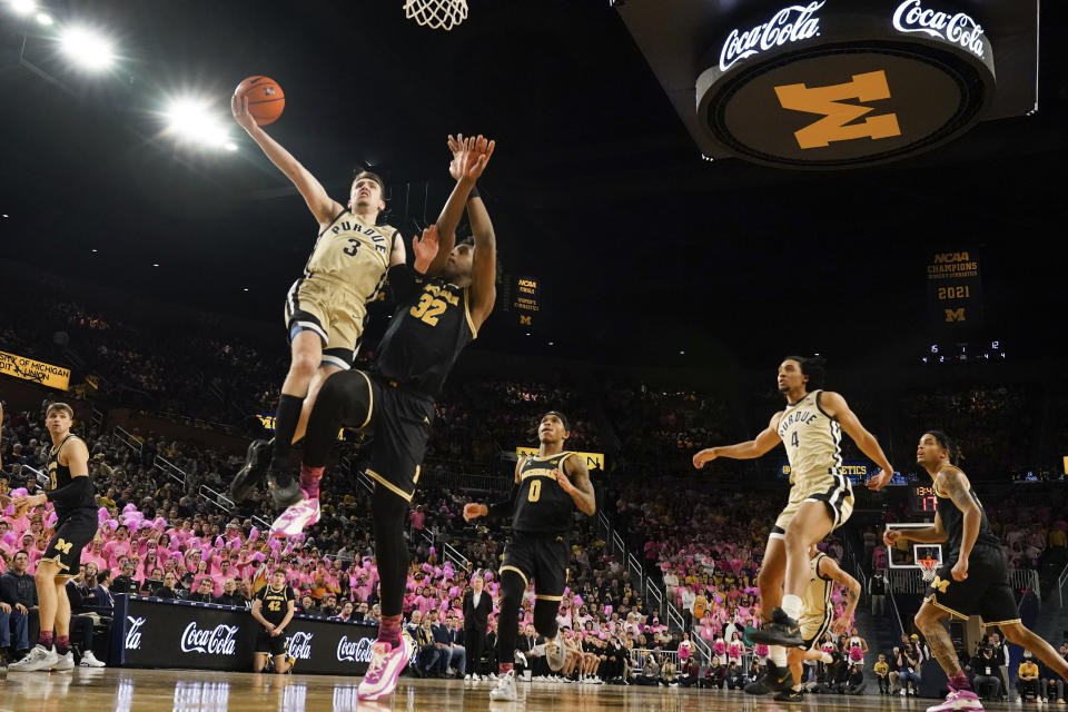 Purdue guard Braden Smith (3) drives on Michigan forward Tarris Reed Jr. (32) in the first half of an NCAA college basketball game in Ann Arbor, Mich., Thursday, Jan. 26, 2023. (AP Photo/Paul Sancya)