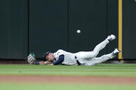 Seattle Mariners left fielder Jarred Kelenic dives for and misses a fly ball from Texas Rangers' Willie Calhoun in the sixth inning of a baseball game, Thursday, May 27, 2021, in Seattle. Calhoun tripled on the play. (AP Photo/Elaine Thompson)