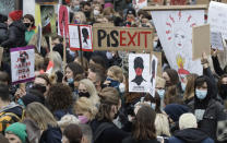 Women's rights activists hold placards during a protest in Warsaw, Poland, Wednesday, Oct. 28, 2020 against recent tightening of Poland's restrictive abortion law. Massive nationwide protests have been held ever since a top court ruled Thursday that abortions due to fetal congenital defects are unconstitutional.(AP Photo/Czarek Sokolowski)