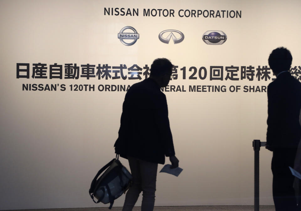 Shareholders arrive at a conference hall to attend Nissan's general meeting of shareholders in Yokohama, near Tokyo, Tuesday, June 25, 2019. Japanese automaker Nissan faces shareholders as profits and sales tumble after its former star chairman faces trial on financial misconduct allegations.(AP Photo/Koji Sasahara)