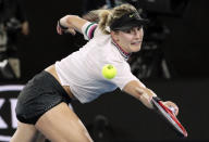 Canada's Eugenie Bouchard reaches for a backhand return to United States' Serena Williams during their second round match at the Australian Open tennis championships in Melbourne, Australia, Thursday, Jan. 17, 2019. (AP Photo/Aaron Favila)