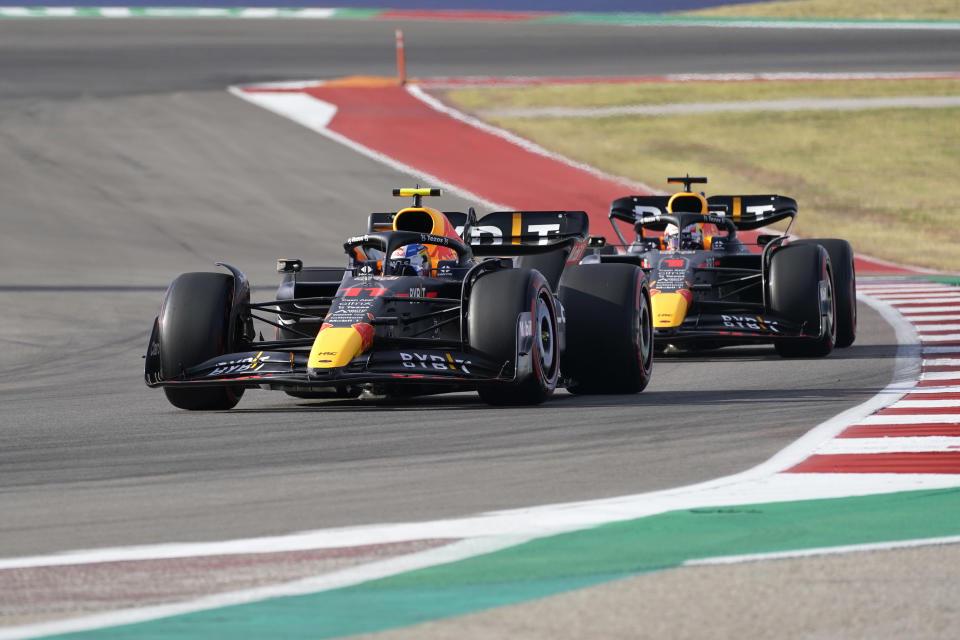 Red Bull driver Sergio Perez, left, of Mexico, leads Red Bull driver Max Verstappen, of the Netherlands, during qualifications at the Formula One U.S. Grand Prix auto race at Circuit of the Americas, Saturday, Oct. 22, 2022, in Austin, Texas. (AP Photo/Darron Cummings)