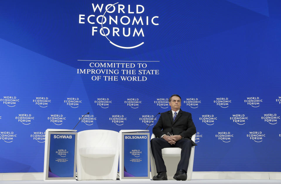 Jair Bolsonaro, President of Brazil, takes his seat for a session at the annual meeting of the World Economic Forum in Davos, Switzerland, Tuesday, Jan. 22, 2019. (AP Photo/Markus Schreiber)