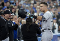 New York Yankees' Aaron Judge celebrates his 61st home run of the season, a two-run shot against the Toronto Blue Jays, and acknowledges his family during seventh inning of a baseball game Wednesday, Sept. 28, 2022, in Toronto. (Nathan Denette/The Canadian Press via AP)