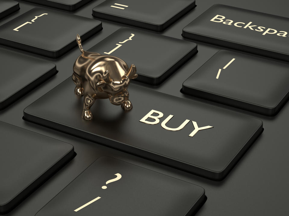 A gold bull on top of a keyboard button labeled "Buy"