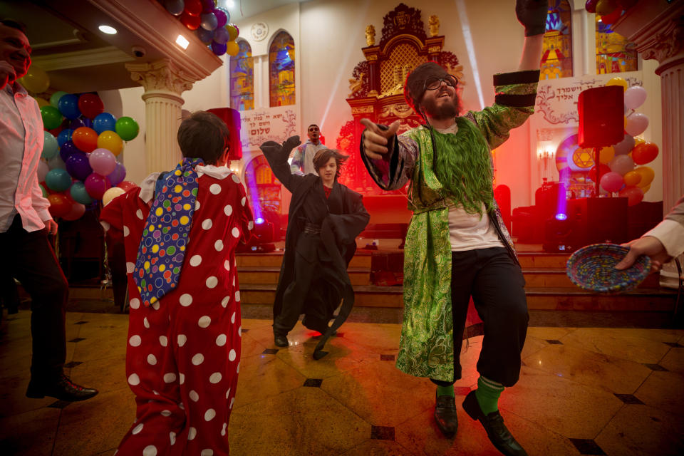 Members of the Ukrainian Jewish community dance to "Purim Style," a local cover of "Gangnam Style," during Purim celebrations and a festive meal at the Great Choral Synagogue in Kyiv, Ukraine, Sunday, March 24, 2024. (AP Photo/Vadim Ghirda)