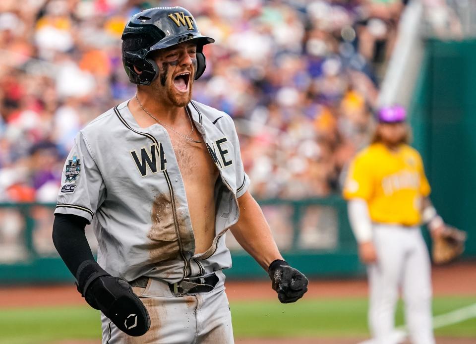 Wake Forest Demon Deacons catcher Bennett Lee (27) celebrates after scoring on a two-run single by center fielder Tommy Hawke (not pictured) against the LSU Tigers during the second inning at Charles Schwab Field Omaha on June 21, 2023.