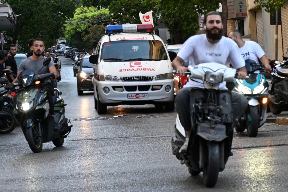 An ambulance can be seen rushing towards a hospital after the pager detonations (EPA)