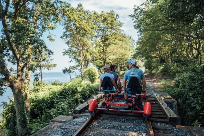 <p>WIth <a href="https://www.railexplorers.net" rel="nofollow noopener" target="_blank" data-ylk="slk:Rail Explorers" class="link ">Rail Explorers</a>, you can pedal the rails that track along the coastal tip of Aquidneck Island, which encompasses Portsmouth, Middletown, and Newport. It's an activity that anyone can enjoy—no matter their age.<br></p>