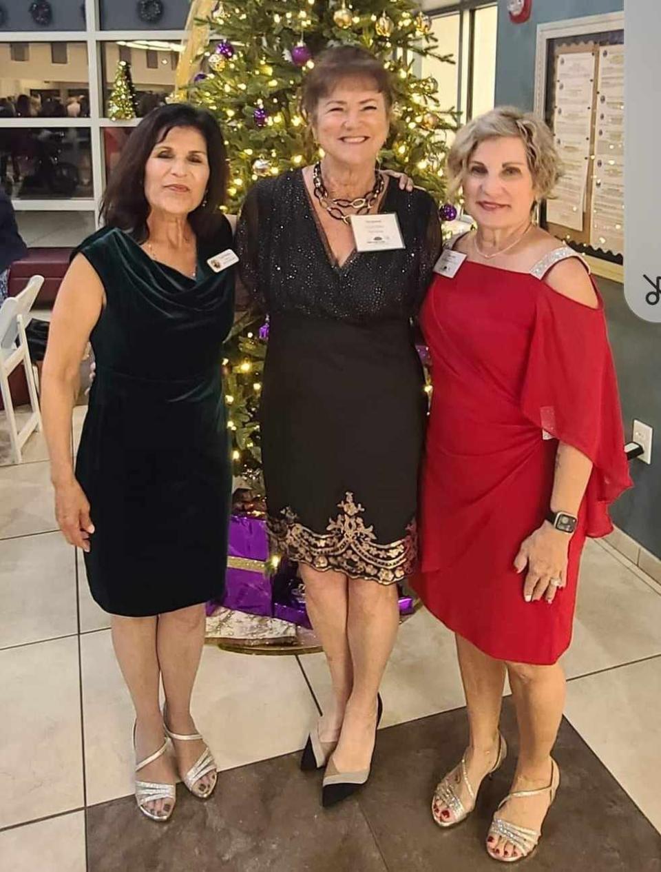 Kat Atwood, center, celebrates Christmas with mayors Lois Paritsky of Ponce Inlet, left, and Nancy Miller of Daytona Beach Shores, right. Both mayors have agreed to recognize World Encephalitis Day at Atwood's request.