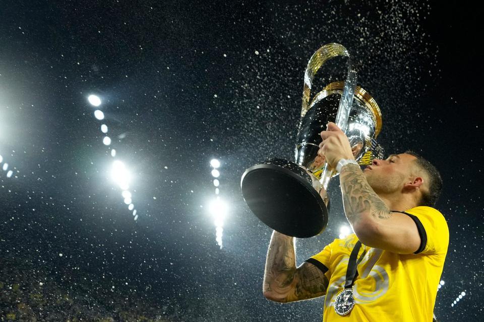 Crew forward Christian Ramirez hoists the Philip J. Anschutz Trophy after defeating Los Angeles FC in the 2023 MLS Cup championship game.