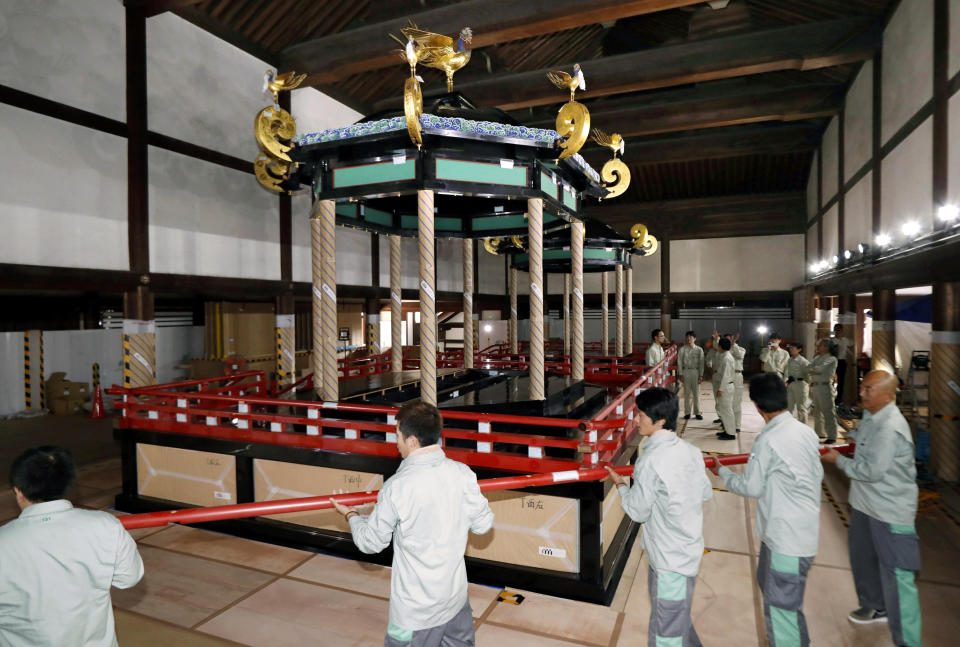 In this Aug. 20, 2018, photo, Takamikura throne, left, is disassembled at the Kyoto Imperial Palace in Kyoto, western Japan, to be transported to Imperial Palace in Tokyo. The special imperial throne for the coronation of Japan’s new emperor arrived in Tokyo on Wednesday, Sept. 26, 2018, from the ancient imperial palace more than a year ahead of time. The Takamikura throne will be used at a ceremony in October 2019 when Crown Prince Naruhito formally announces his succession. (Kyodo News via AP)