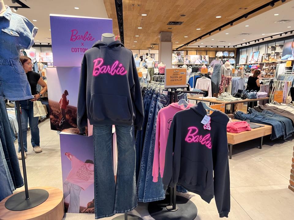 Barbie-themed clothing at Cotton On store in a mall.