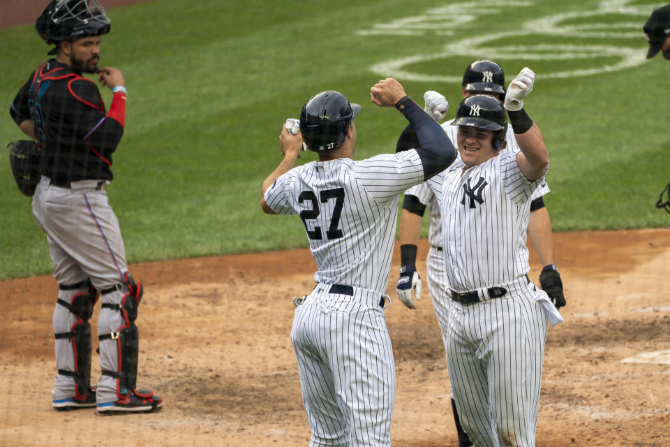 Miami Marlins catcher Jorge Alfaro looks on as New York Yankees' Luke Voit celebrates a three-run home run with Giancarlo Stanton in the sixth inning of a baseball game at Yankee Stadium, Saturday, Sept. 26, 2020, in New York. (AP Photo/Corey Sipkin)