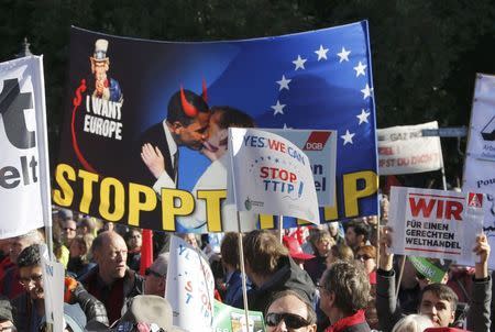 Consumer rights activists take part in a march to protest against the Transatlantic Trade and Investment Partnership (TTIP), mass husbandry and genetic engineering, in Berlin, Germany, October 10, 2015. REUTERS/Fabrizio Bensch