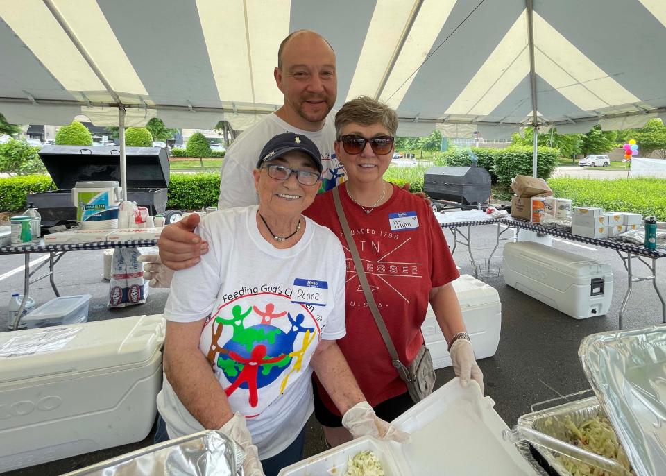 Volunteer Donna Blankenship, treasurer Luke Loveday, and volunteer Mimi Loveday serve up hundreds of servings of chicken and ribs.