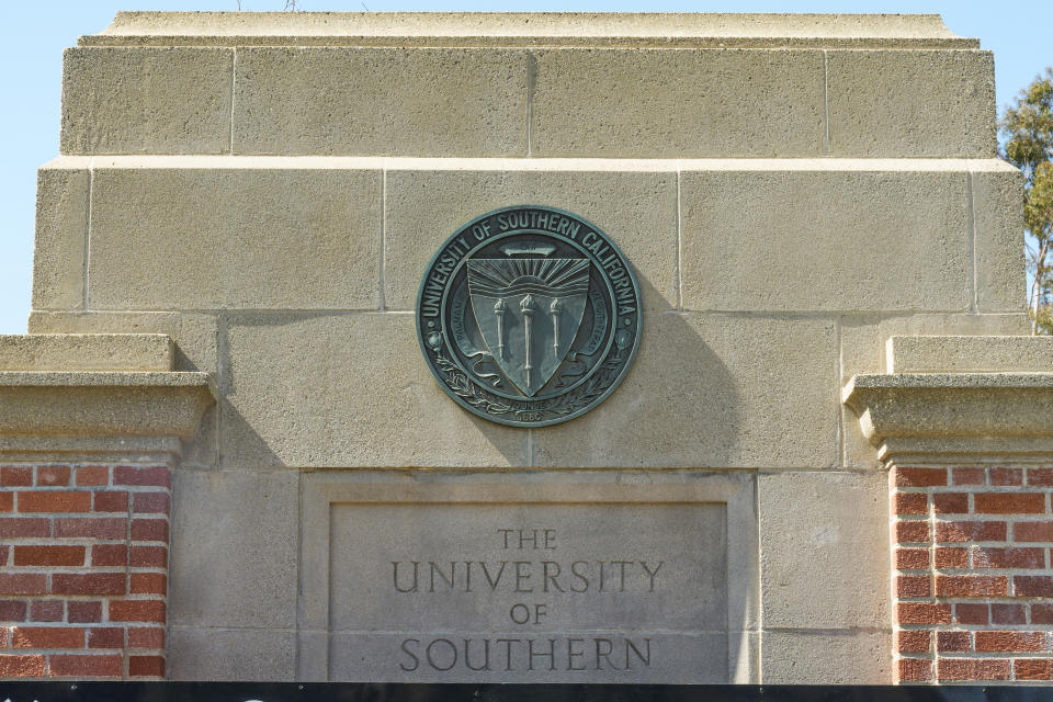 The emblem for the University of Southern California is mounted at a campus entrance in Los Angeles Tuesday, April 16, 2024. University of Southern California officials have canceled a commencement speech by its 2024 valedictorian, a pro-Palestinian Muslim, citing "substantial risks relating to security and disruption" of the event that draws 65,000 people to campus. (AP Photo/Damian Dovarganes)