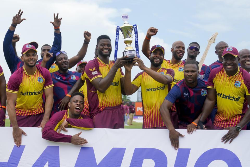 Players of West Indies celebrate with the trophy after beating India in the fifth and last T20 cricket match at Central Broward Regional Park in Lauderhill, Fla, Sunday, Aug. 13, 2023. (AP Photo/Ramon Espinosa)