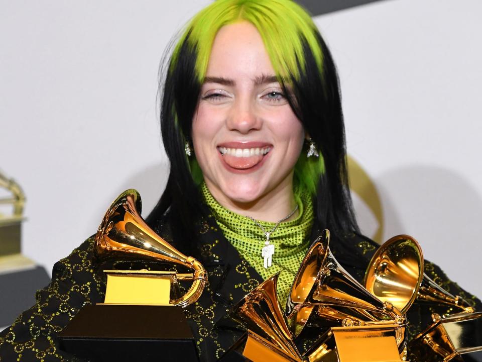 billie eilish holding four grammy awards