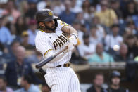 San Diego Padres shortstop Fernando Tatis Jr. hits an RBI double against the Colorado Rockies during the first inning of a baseball game Thursday, July 29, 2021, in San Diego. (AP Photo/Derrick Tuskan)