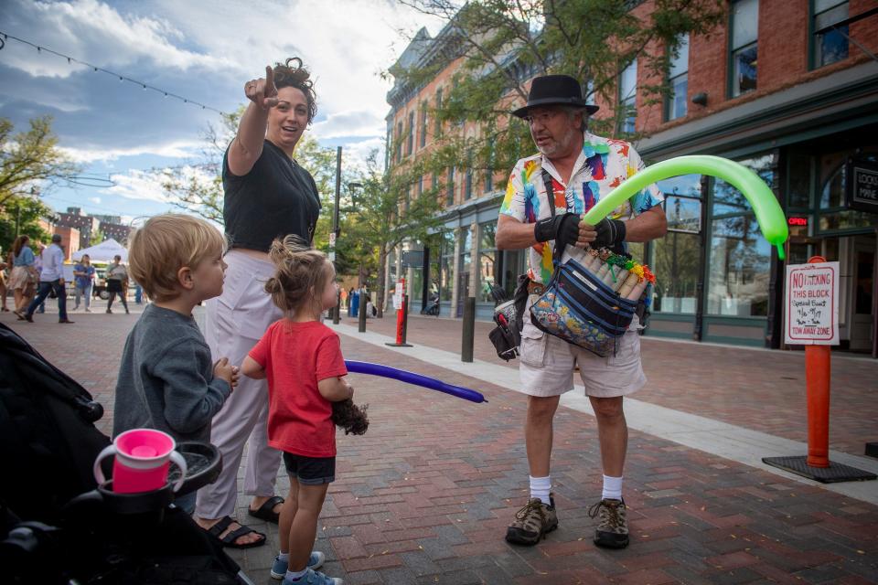 Balloon artist Steve Solis makes a balloon sword during an event on Linden Street in Old Town Fort Collins on Sept. 16, 2022.