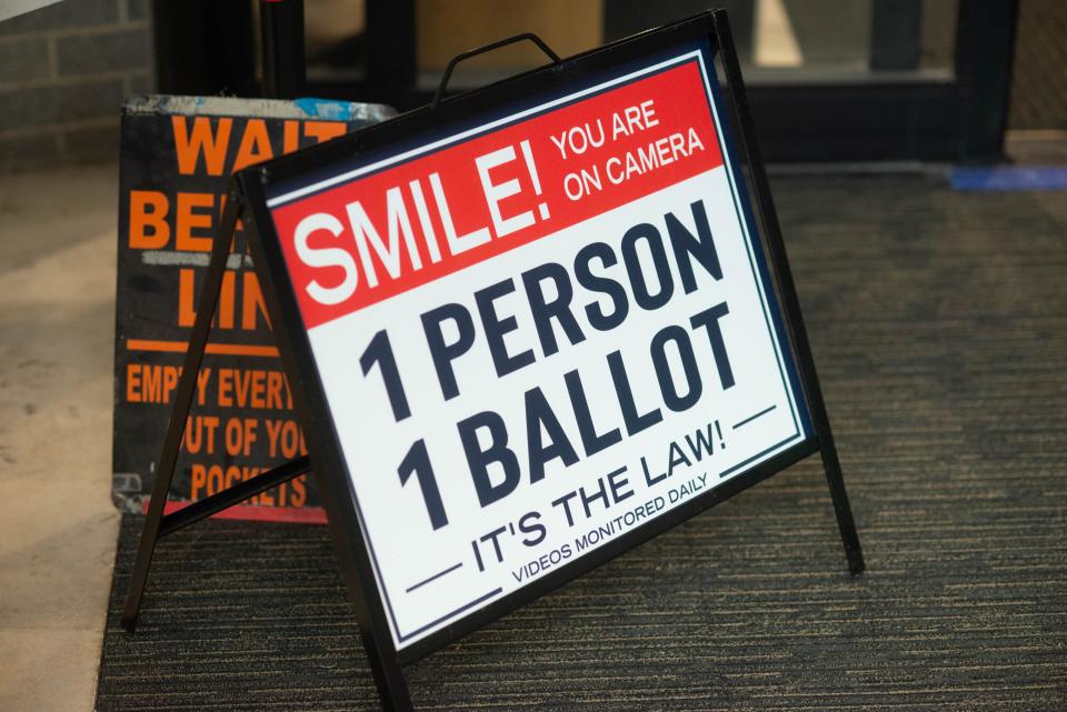 A sign reads '1 person 1 ballot' as voters start to return their mail-in ballots to the county drop box Friday, May 13, 2022 at Bucks County Administration Building in Doylestown.