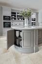 <p> Curved cabinetry offers practical storage that simply takes up less floor space than square-cornered pieces. </p> <p> 'The kitchen island is often a hive of activity with cooking, eating, work, learning, and play centered around this area,' says Tom Howley. </p> <p> 'When designing a kitchen island, it is essential to consider both internal solutions and exterior proportions. Many aspects of your kitchen design can determine your kitchen island size and shape. You can opt for integrated bench seating, consider extra knee room for practical kitchen seating ideas – or design a bespoke circular table if you have the room.' </p>