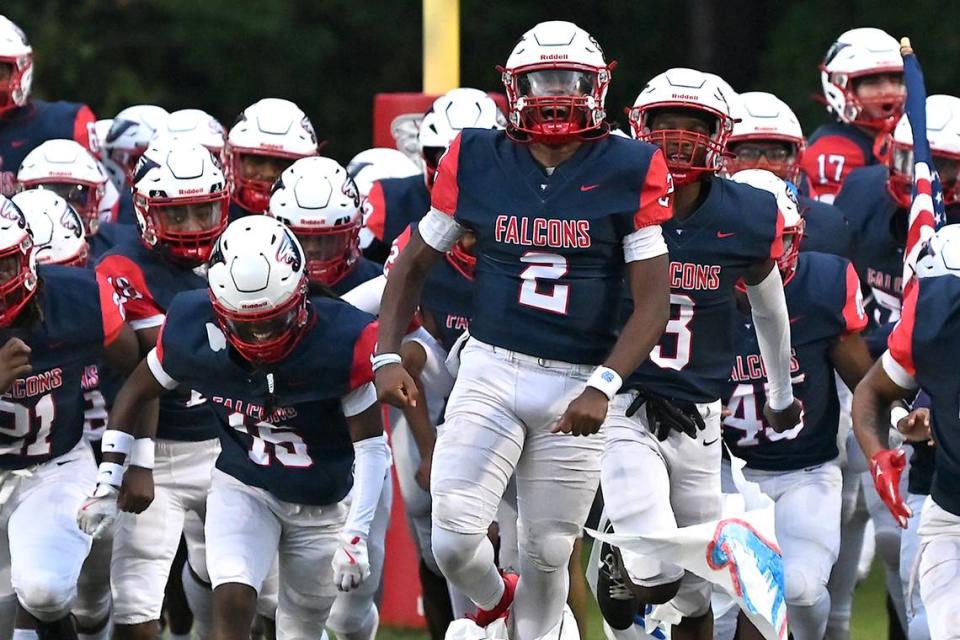 Jordan quarterback Landon Melton (2) runs onto the field with teammates before their game with Smithfield-Selma. The Durham Jordan Falcons and the Smithfield-Selma Spartans met in a football game in Durham, N.C. on September 13, 2024.