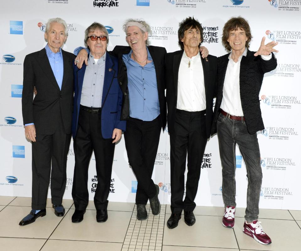 FILE - This Oct. 18, 2012 file photo shows, from left, Charlie Watts, Bill Wyman, Keith Richards, Ronnie Wood and Mick Jagger of The Rolling Stones at London Film Festival American Express Gala for their film, "The Rolling Stones - Crossfire Hurricane" at Odeon West End in London. The archetypal rock 'n' roll band is set for five concerts in London and the New York area over the next month, released another hits compilation with two new songs on Tuesday, Nov. 13, and will see HBO premiere a documentary on their formative years, "Crossfire Hurricane," on Thursday Nov. 15. Wyman was a member of the band until 1993. (Photo by Jon Furniss/Invision/AP, file)