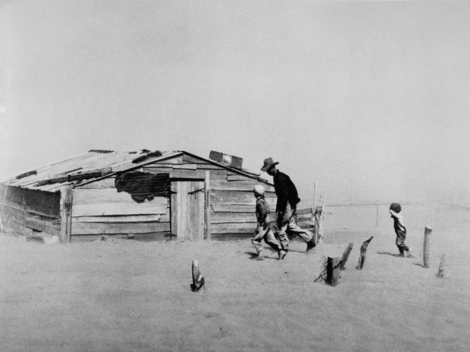 Farmer and his two sons during a dust storm in Oklahoma in 1936.